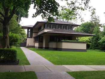 Lawn by building against sky