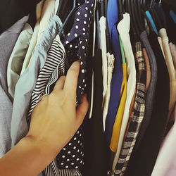 A woman's hand choosing clothes