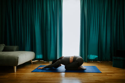 Man lying down on floor at home