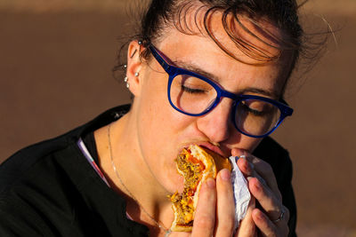 Close-up of woman eating burger