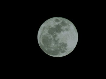 Low angle view of moon against clear sky at night