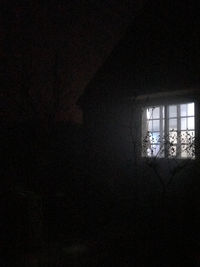 Silhouette building seen through window