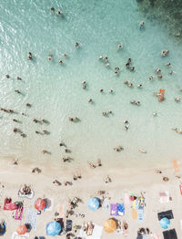 High angle view of people swimming in sea