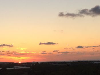 Scenic view of sunset over city