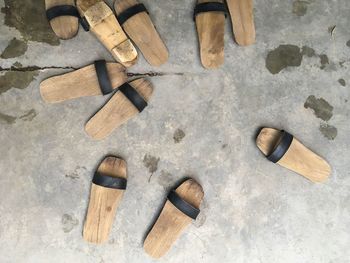 High angle view of wooden footwear on footpath