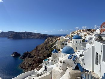 Panoramic view of buildings and sea against blue sky
