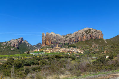 View of aguero village and los mallos mountains behind it, aragon, spain