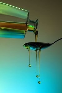 Close-up of olive oil pouring on spoon