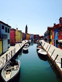 Boats in canal along buildings