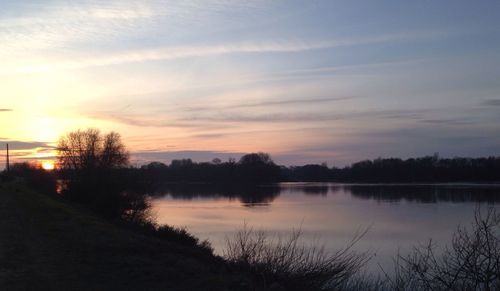 Scenic view of lake at sunset