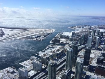 Aerial view of billy bishop toronto city airport and city against sky