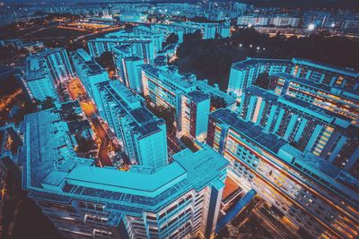 High angle view of city lit up at night