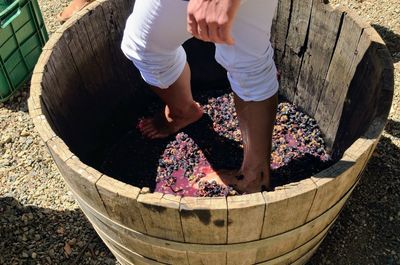 Low section of man walking in barrel