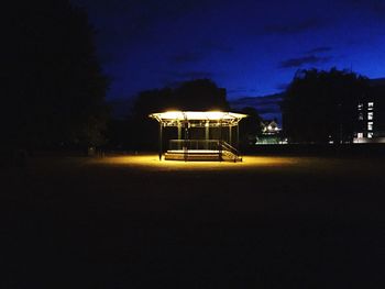 Illuminated house against sky at night