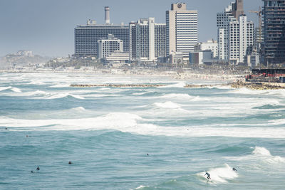 Scenic view of sea and buildings against sky