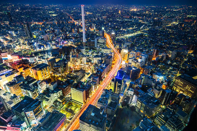 High angle view of city lit up at night