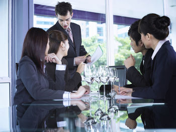 Smiling colleagues with drinks at restaurant during meeting