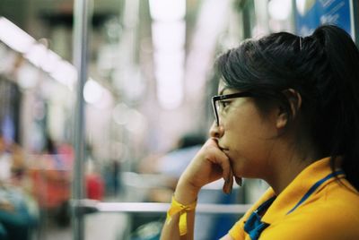 Side view of woman wearing eyeglasses