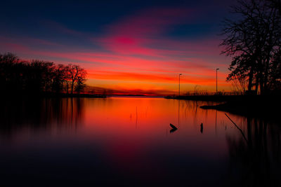 Scenic view of lake against sky during sunset