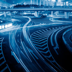 High angle view of light trails on road in city at night