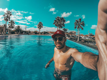 Portrait of shirtless man in swimming pool