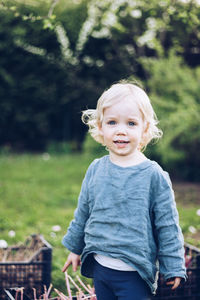 Portrait of cute baby girl standing in park