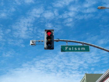 Low angle view of road sign against sky