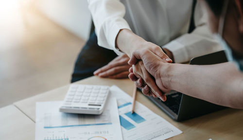 Midsection of woman working on table