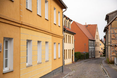 Street amidst buildings against sky