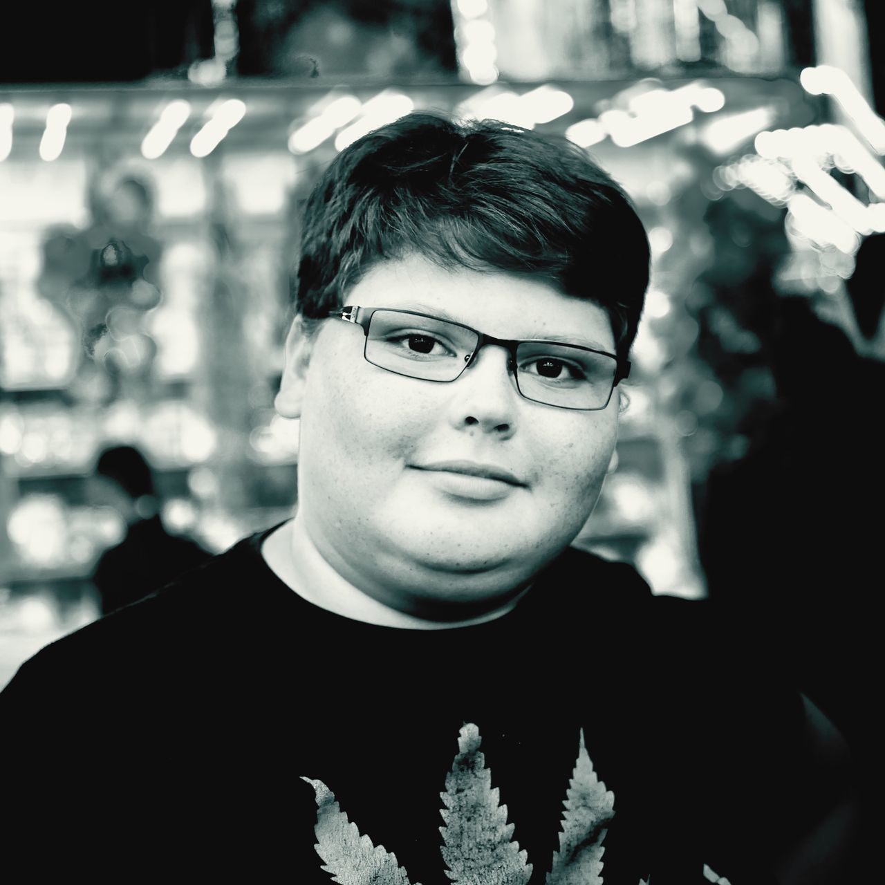 PORTRAIT OF YOUNG MAN WITH EYEGLASSES