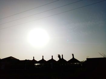 Silhouette buildings against sky during sunset