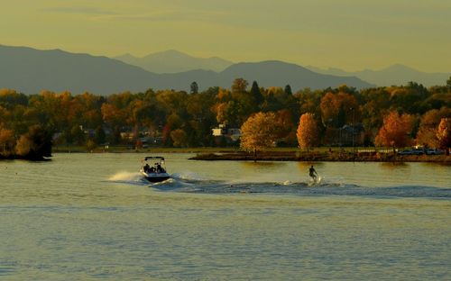 Man waterskiing on lake