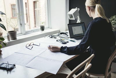 Female engineer working on desk at home office