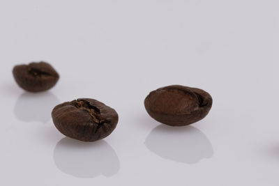 Close-up of fruits on table against white background