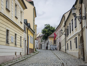 Empty alley amidst buildings in city