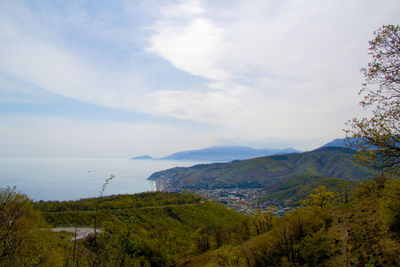 Scenic view of mountains against cloudy sky