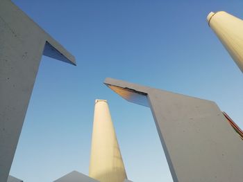 Low angle view of airplane against clear blue sky