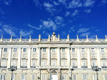 Low angle view of building against cloudy sky