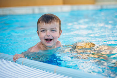 Portrait of cute boy in swimming pool