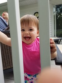 Close-up portrait of smiling girl playing in playground