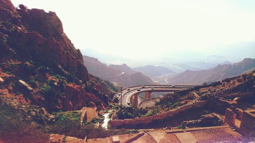 Scenic view of valley and mountains against sky