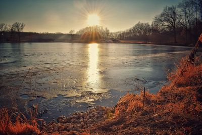 View of frozen lake during sunset