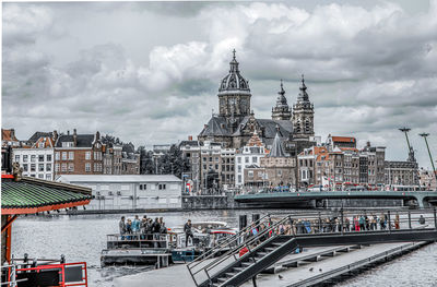 High angle view of buildings in city against cloudy sky