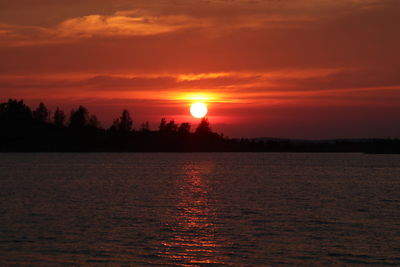 Scenic view of sea against romantic sky at sunset