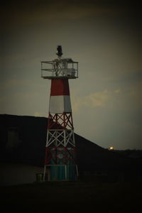 Lighthouse against sky at sunset