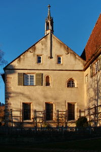 Low angle view of building against clear blue sky