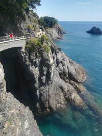 Rock formations by sea against sky