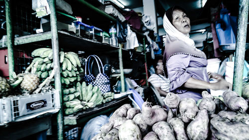 Woman selling vegetables at market