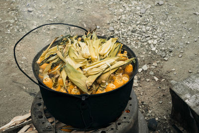 High angle view of corns in container cooking on stove