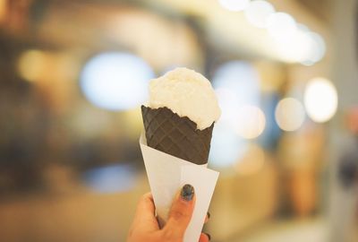 Close-up of hand holding ice cream cone